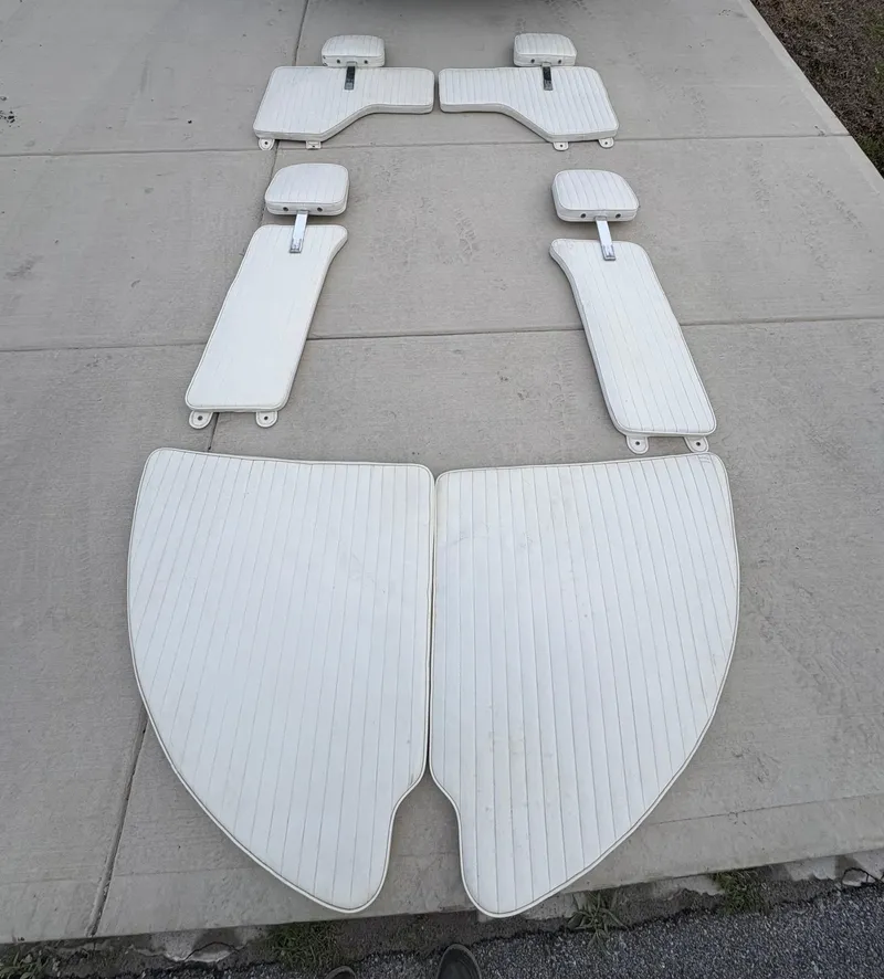 Slide: The Image of White boat cushions arranged on pavement, Savannah SS21 model, 2021. - 11