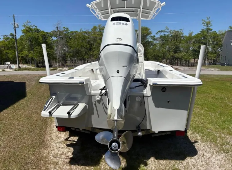 Slide: The Image of 2021 Savannah SS21 boat with outboard motor, parked on grass. - 3