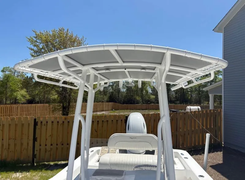 Slide: The Image of Savannah SS21 boat with T-top canopy, parked outdoors, 2021 model. - 7