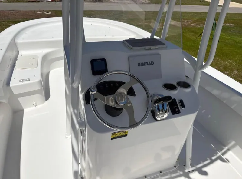Slide: The Image of Center console of a 2021 Savannah SS21 boat with steering wheel and controls. - 9