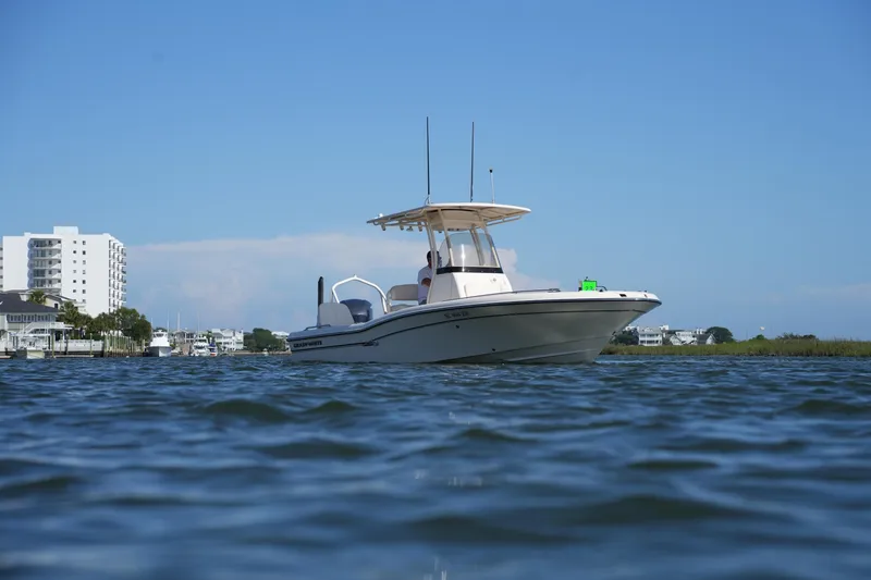 Slide: The Image of 2016 Grady-White 251 Coastal Explorer boat on calm water, clear sky background. - 10