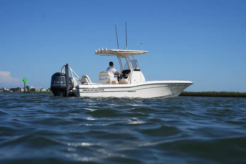 Slide: The Image of 2016 Grady-White 251 Coastal Explorer boat on calm water under clear blue sky. - 2