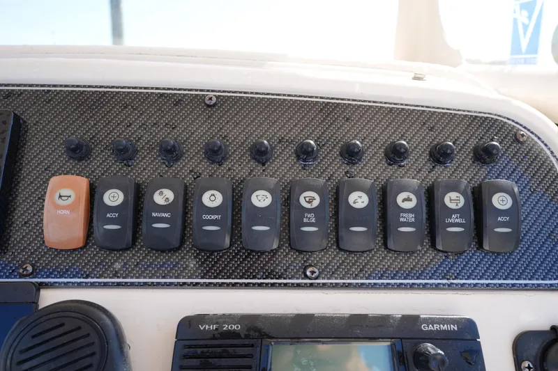Slide: The Image of Control panel of 2016 Grady-White 251 Coastal Explorer boat with various switches and Garmin device. - 23