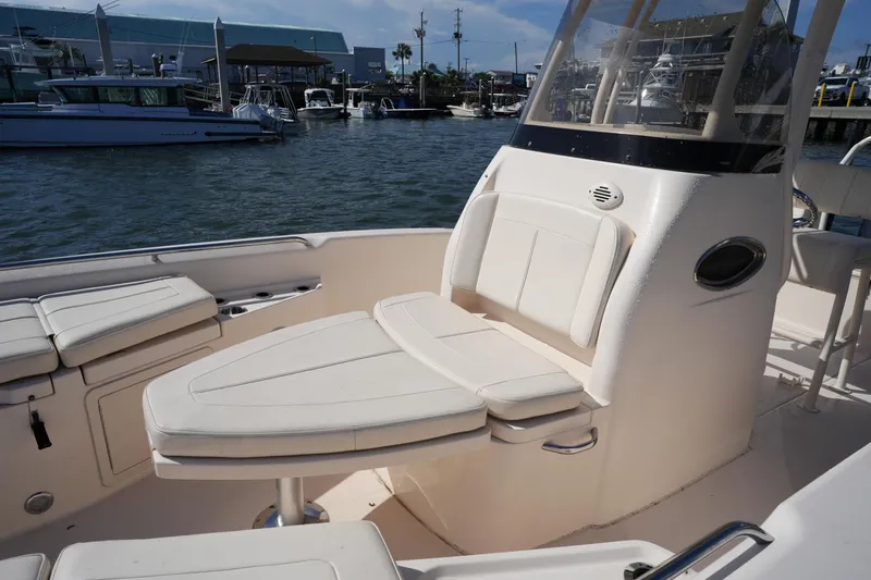 Slide: The Image of 2016 Grady-White 251 Coastal Explorer boat interior with seating, docked at marina. - 29