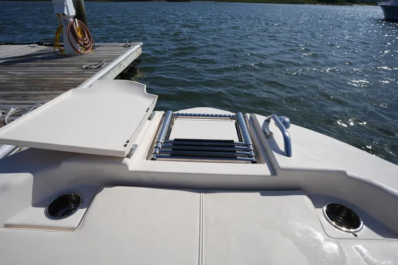 Slide: The Image of 2016 Grady-White 251 Coastal Explorer boat with open hatch and ladder by the dock. - 34