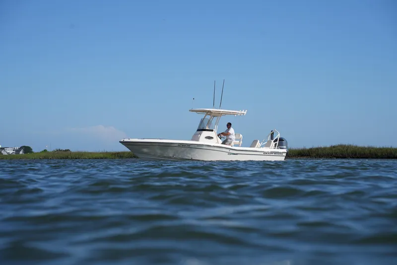 Slide: The Image of 2016 Grady-White 251 Coastal Explorer boat on calm water, clear sky background. - 6
