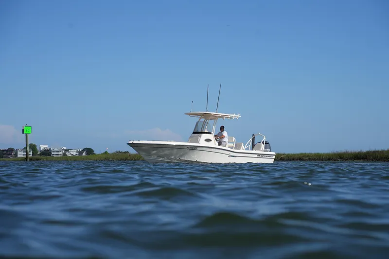 Slide: The Image of 2016 Grady-White 251 Coastal Explorer boat on calm water under clear blue sky. - 7