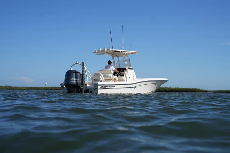 Slide: The Image of 2016 Grady-White 251 Coastal Explorer boat on calm water under clear blue sky. - 9