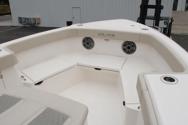 Slide: The Image of 2024 Solace 32 CS boat interior with seating and speakers, showcasing modern design. - 12