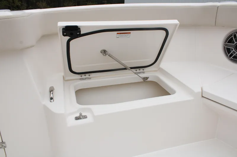 Slide: The Image of 2024 Solace 32 CS boat storage compartment with open hatch and hydraulic support. - 14