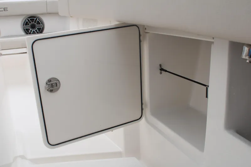 Slide: The Image of 2024 Solace 32 CS boat storage compartment with open door, showcasing interior space. - 16