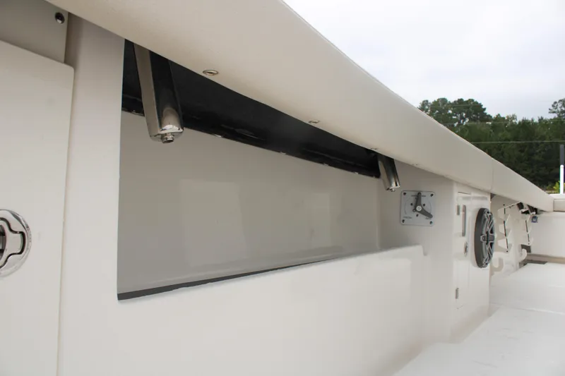 Slide: The Image of 2024 Solace 32 CS boat interior storage compartment with sleek design and modern features. - 17