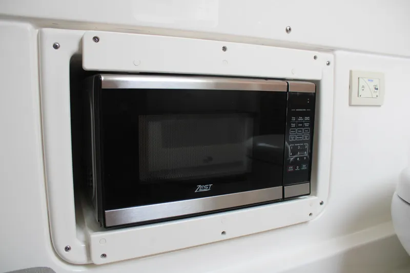 Slide: The Image of Built-in microwave in 2024 Solace 32 CS boat interior. - 19