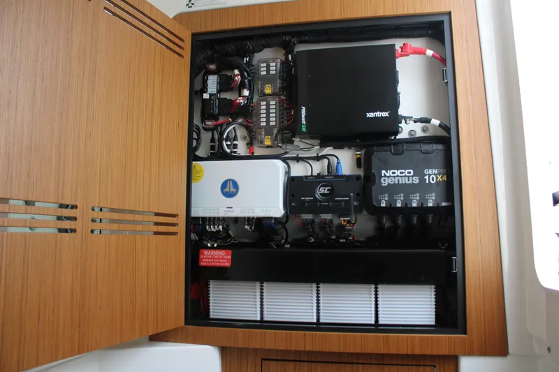 Slide: The Image of Electrical panel inside 2024 Solace 32 CS boat, featuring various components and wiring. - 21
