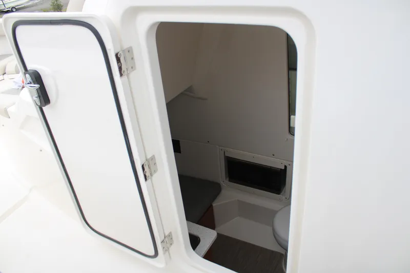 Slide: The Image of 2024 Solace 32 CS boat cabin interior with open door, showcasing compact design. - 24