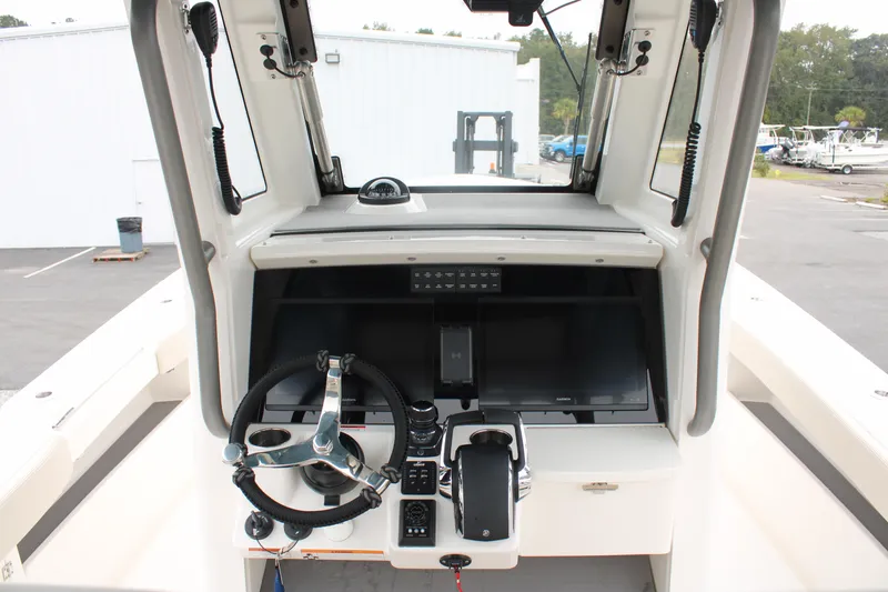 Slide: The Image of 2024 Solace 32 CS boat helm with steering wheel and control panel. - 26