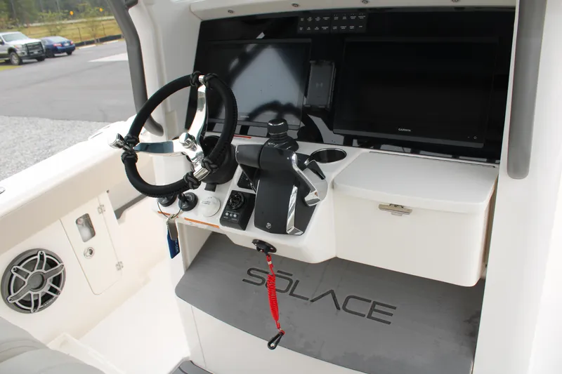 Slide: The Image of 2024 Solace 32 CS boat helm with steering wheel, controls, and display screen. - 29