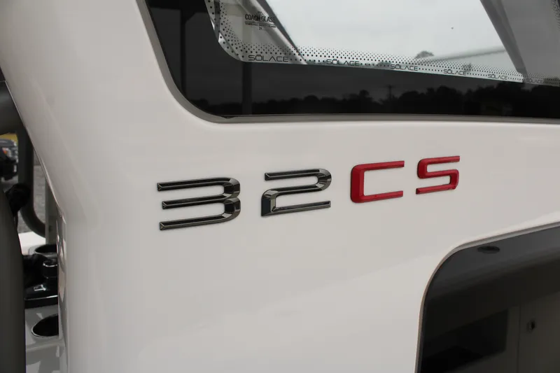 Slide: The Image of 2024 Solace 32 CS boat model emblem on white surface. - 31