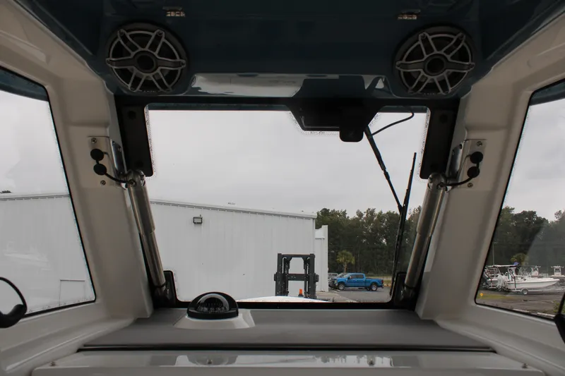 Slide: The Image of Interior view of 2024 Solace 32 CS boat cockpit with speakers and windshield. - 33