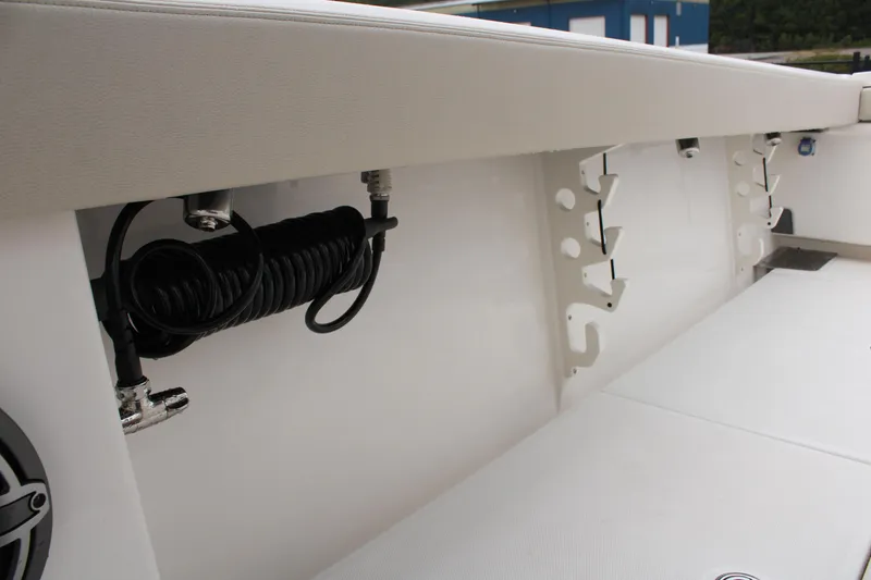 Slide: The Image of 2024 Solace 32 CS boat interior with coiled hose and storage compartments. - 40