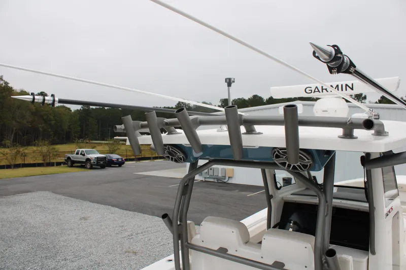 Slide: The Image of 2024 Solace 32 CS boat with rod holders and Garmin equipment, parked outdoors. - 42