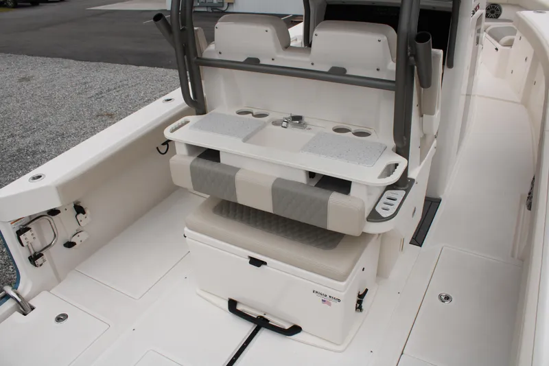Slide: The Image of 2024 Solace 32 CS boat interior with seating, storage, and cup holders. - 43