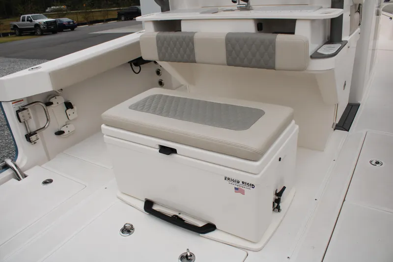 Slide: The Image of 2024 Solace 32 CS boat interior with cushioned seating and storage compartment. - 45