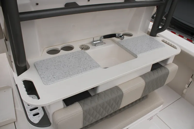 Slide: The Image of 2024 Solace 32 CS boat interior with sink, countertop, and seating area. - 46