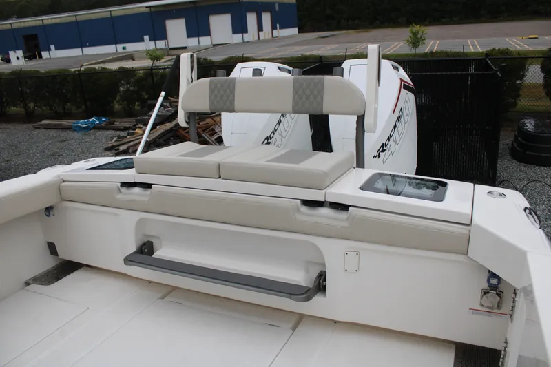 Slide: The Image of 2024 Solace 32 CS boat with cushioned seating and twin outboard engines. - 47