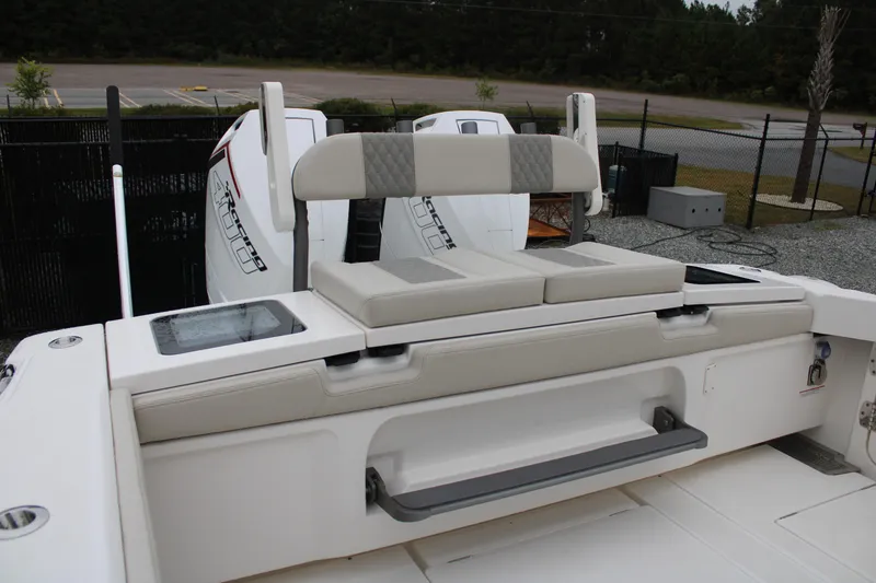 Slide: The Image of 2024 Solace 32 CS boat with cushioned seating and dual outboard motors. - 48