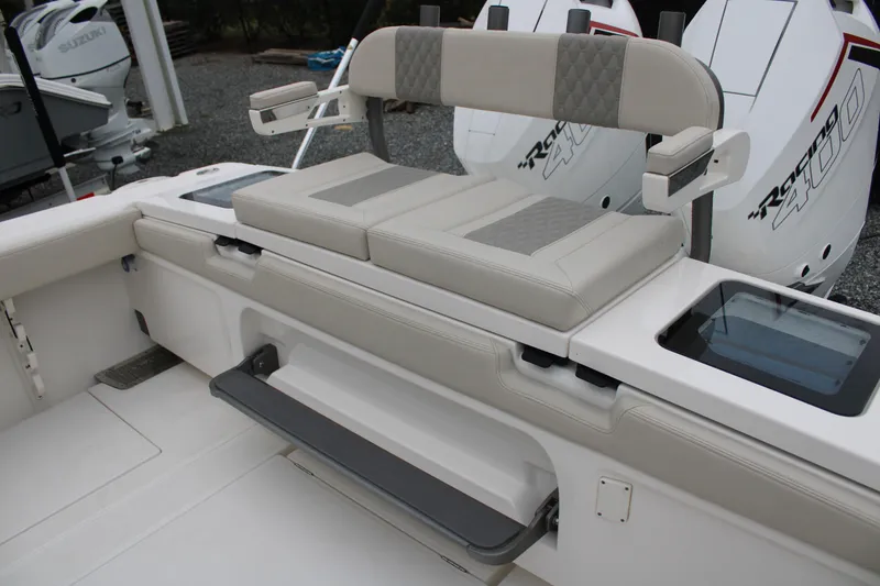 Slide: The Image of 2024 Solace 32 CS boat seating with cushioned bench and storage compartments. - 49