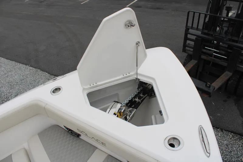 Slide: The Image of 2024 Solace 32 CS boat anchor compartment open, showcasing storage and mechanism. - 6