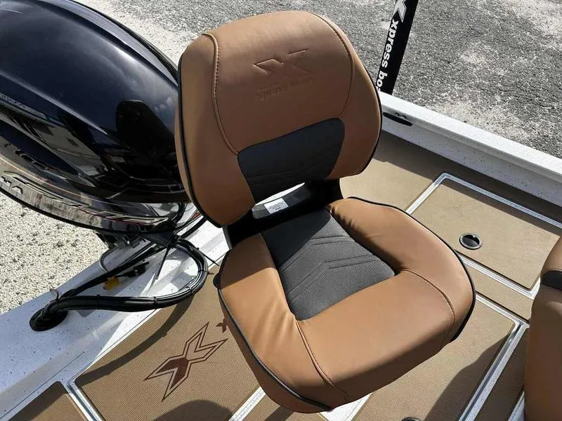 Slide: The Image of 2025 Xpress H18B boat seat with brown and black upholstery. - 11