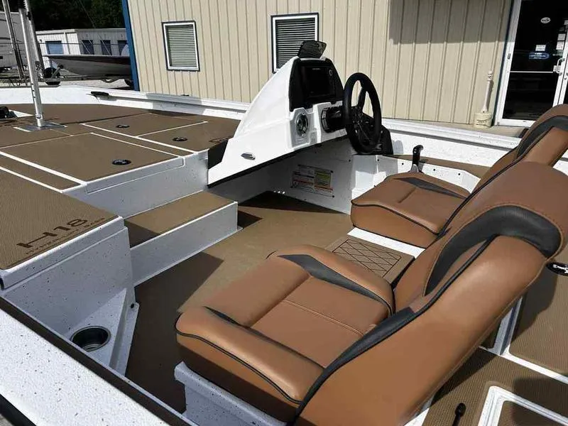 Slide: The Image of 2025 Xpress H18B boat interior with brown seating and modern console design. - 12