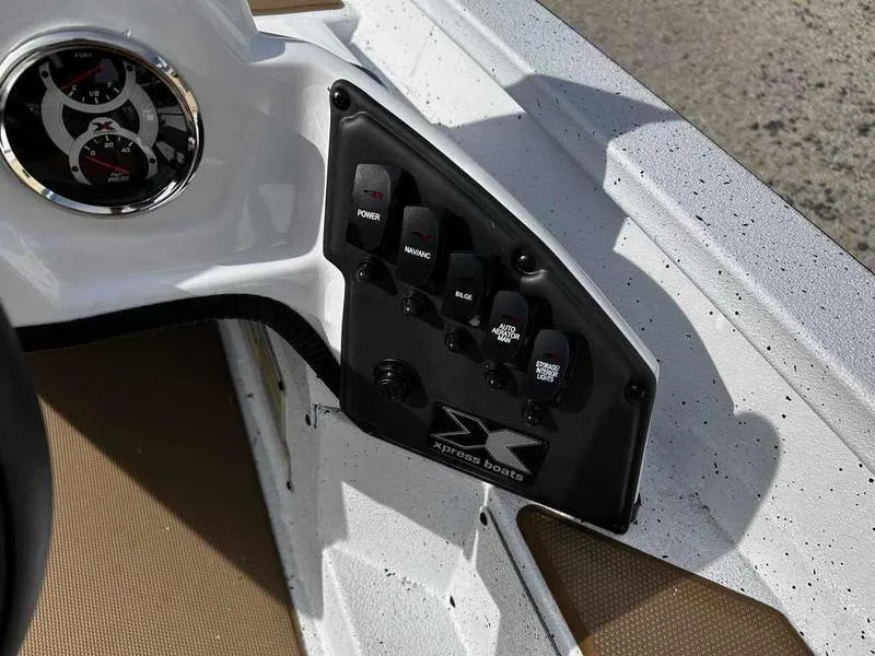 Slide: The Image of Control panel of 2025 Xpress H18B boat with switches and gauge. - 17