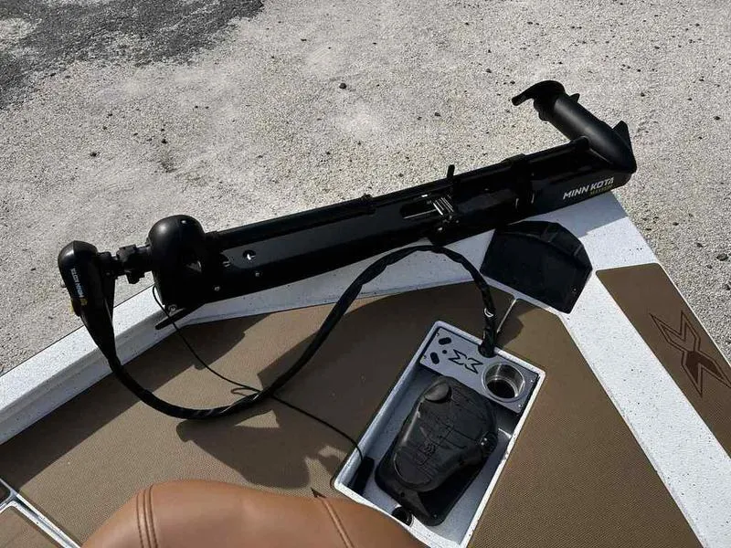 Slide: The Image of 2025 Xpress H18B boat deck with Minn Kota trolling motor and control panel. - 21