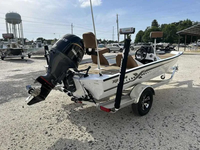 Slide: The Image of 2025 Xpress H18B boat with Yamaha outboard motor on a trailer in a sunny outdoor setting. - 6