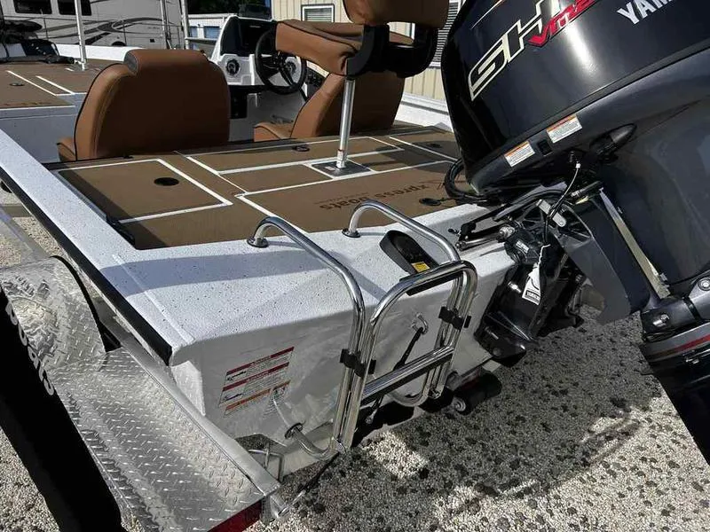 Slide: The Image of 2025 Xpress H18B boat with Yamaha motor and brown seating, featuring a rear ladder. - 9