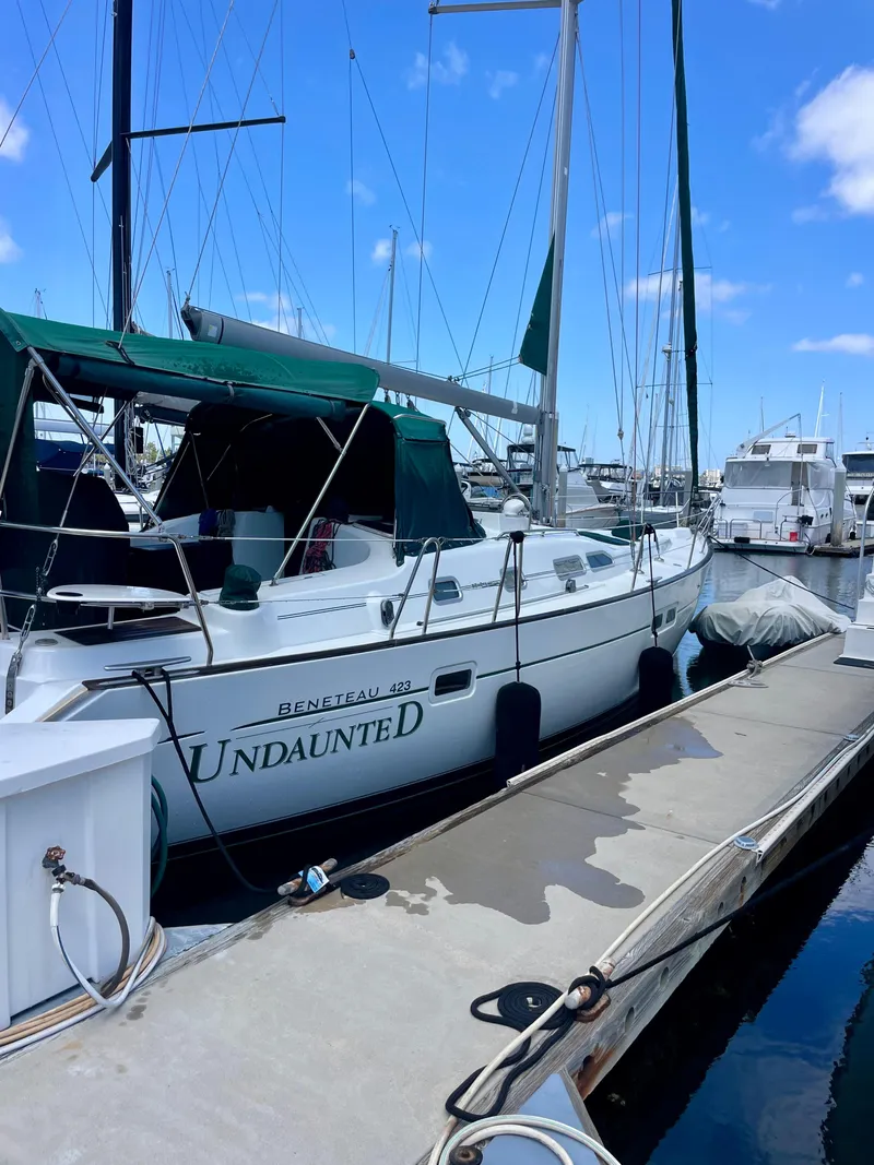 Slide: The Image of 2004 Beneteau 423 sailboat docked at marina under clear blue sky. - 11
