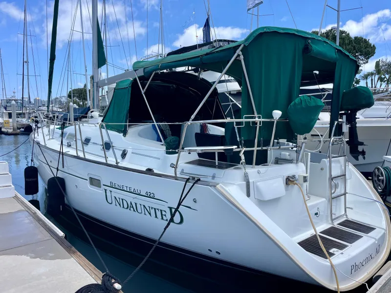 Slide: The Image of 2004 Beneteau 423 sailboat named "Undaunted" docked at a marina. - 12