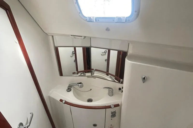 Slide: The Image of Bathroom interior of a 2004 Beneteau 423 yacht, featuring a sink and mirror. - 17