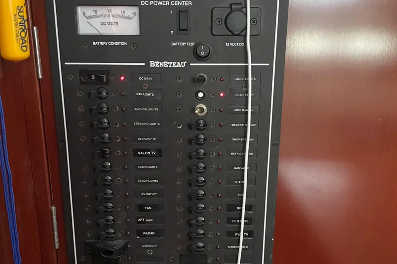 Slide: The Image of Electrical panel of a 2004 Beneteau 423 sailboat, featuring various switches and controls. - 19