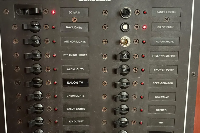 Slide: The Image of Electrical panel of a 2004 Beneteau 423 yacht with labeled switches and indicators. - 21