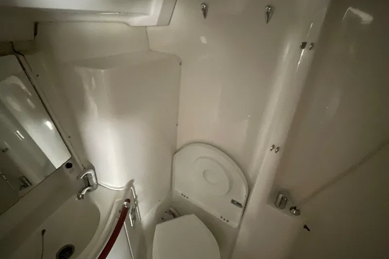 Slide: The Image of Bathroom interior of a 2004 Beneteau 423 yacht, featuring a compact toilet and sink. - 22