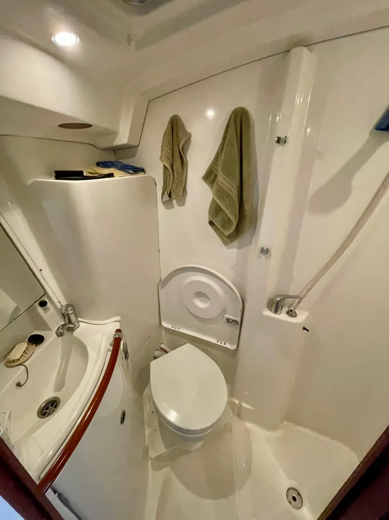 Slide: The Image of Compact bathroom in a 2004 Beneteau 423 sailboat with sink, toilet, and shower. - 4