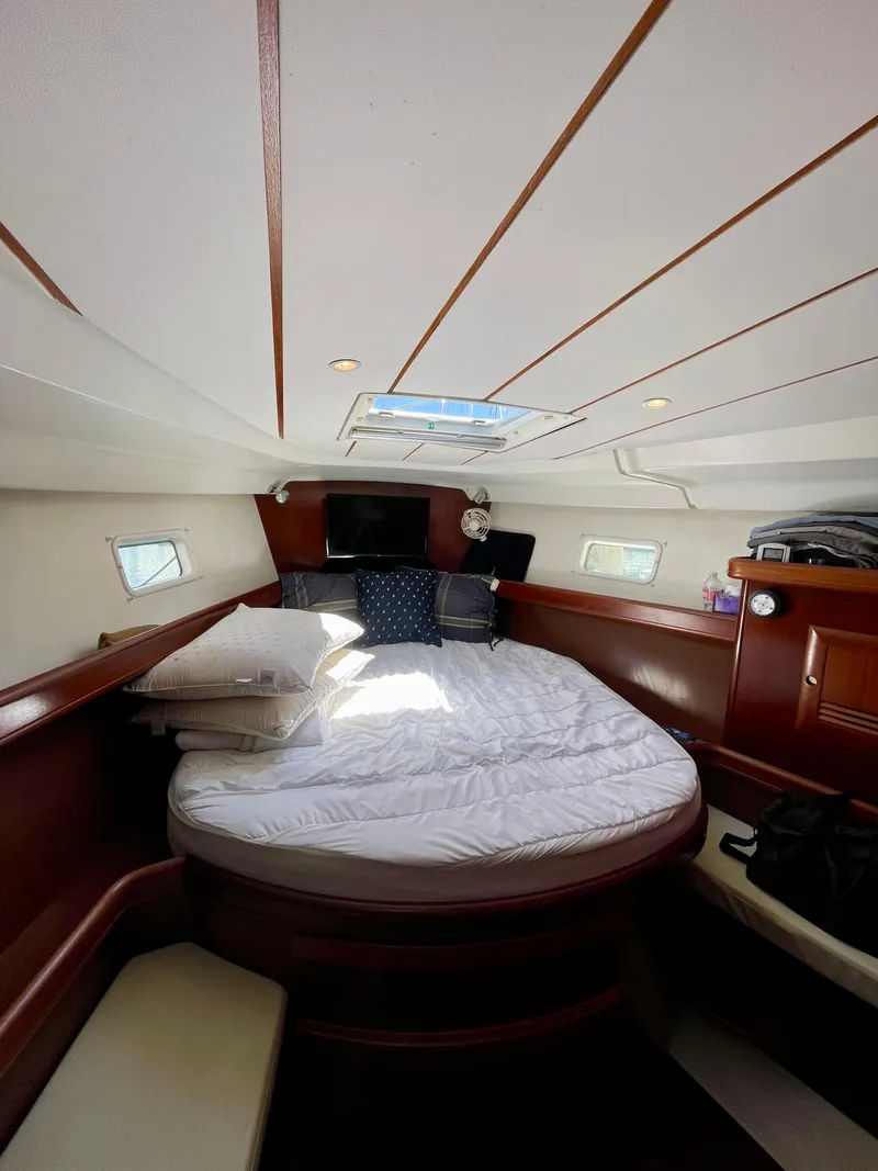 Slide: The Image of Interior cabin of 2004 Beneteau 423 yacht with cozy bed and wooden accents. - 5