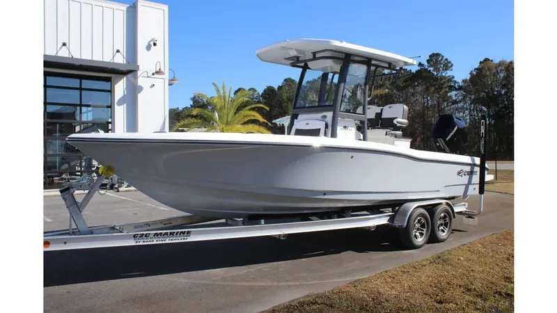 The Image of 2025 Crevalle 26 HCO boat on trailer, parked outdoors near building. - 0