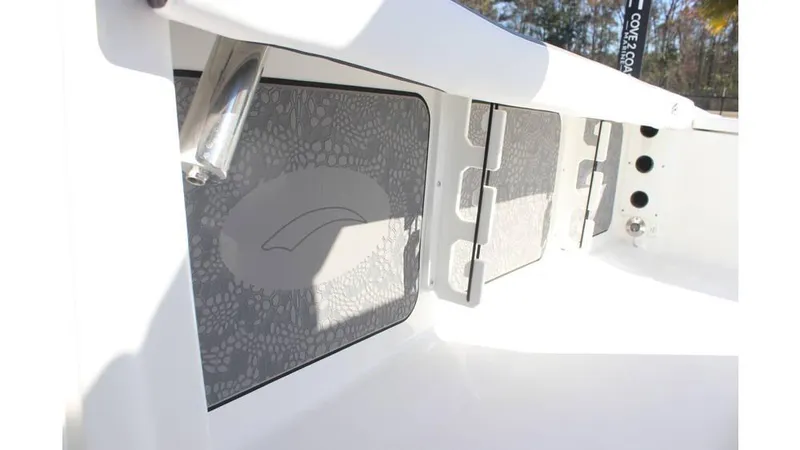 Slide: The Image of 2025 Crevalle 26 HCO boat interior with storage compartments and sleek design. - 15