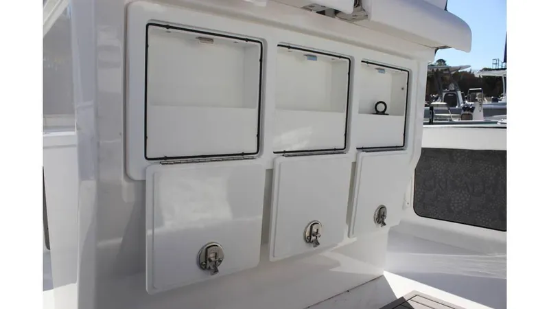 Slide: The Image of Storage compartments on a 2025 Crevalle 26 HCO boat, featuring sleek white design. - 16