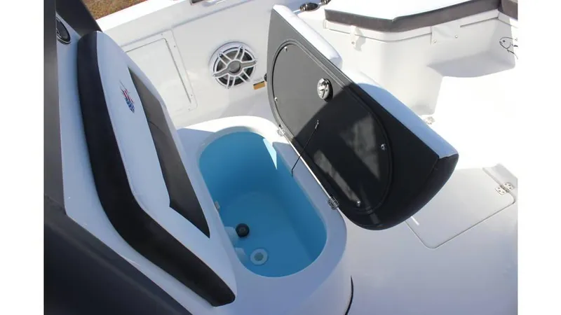 Slide: The Image of 2025 Crevalle 26 HCO boat interior with open storage compartment and speaker. - 27